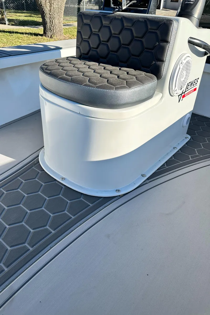 Slide: The Image of 1996 Hewes 18 Redfisher boat seat with hexagonal pattern and speaker detail. - 20