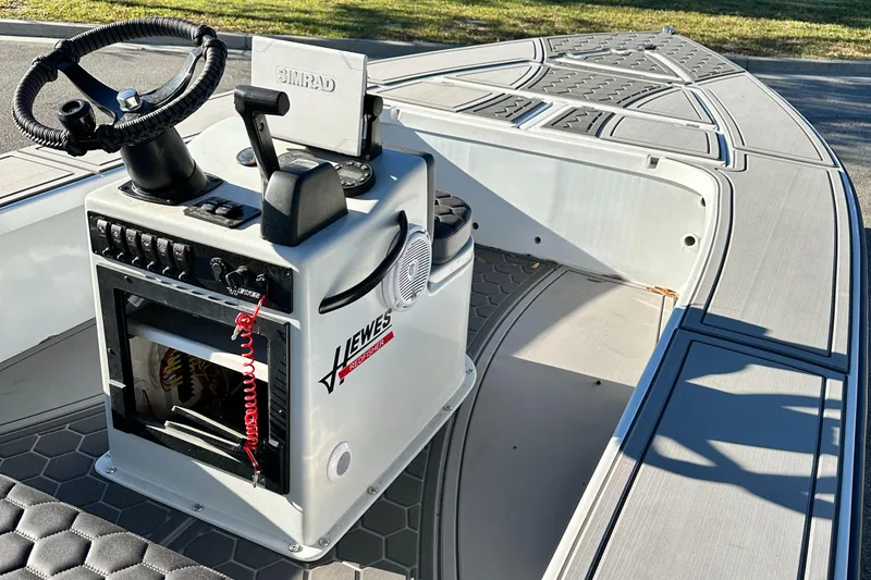 Slide: The Image of 1996 Hewes 18 Redfisher boat interior with steering console and Simrad equipment. - 21