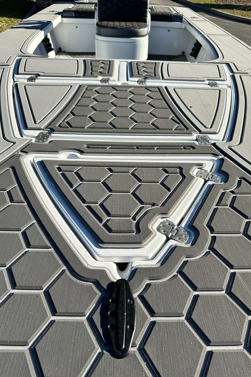 Slide: The Image of 1996 Hewes 18 Redfisher boat deck with hexagonal pattern design. - 22