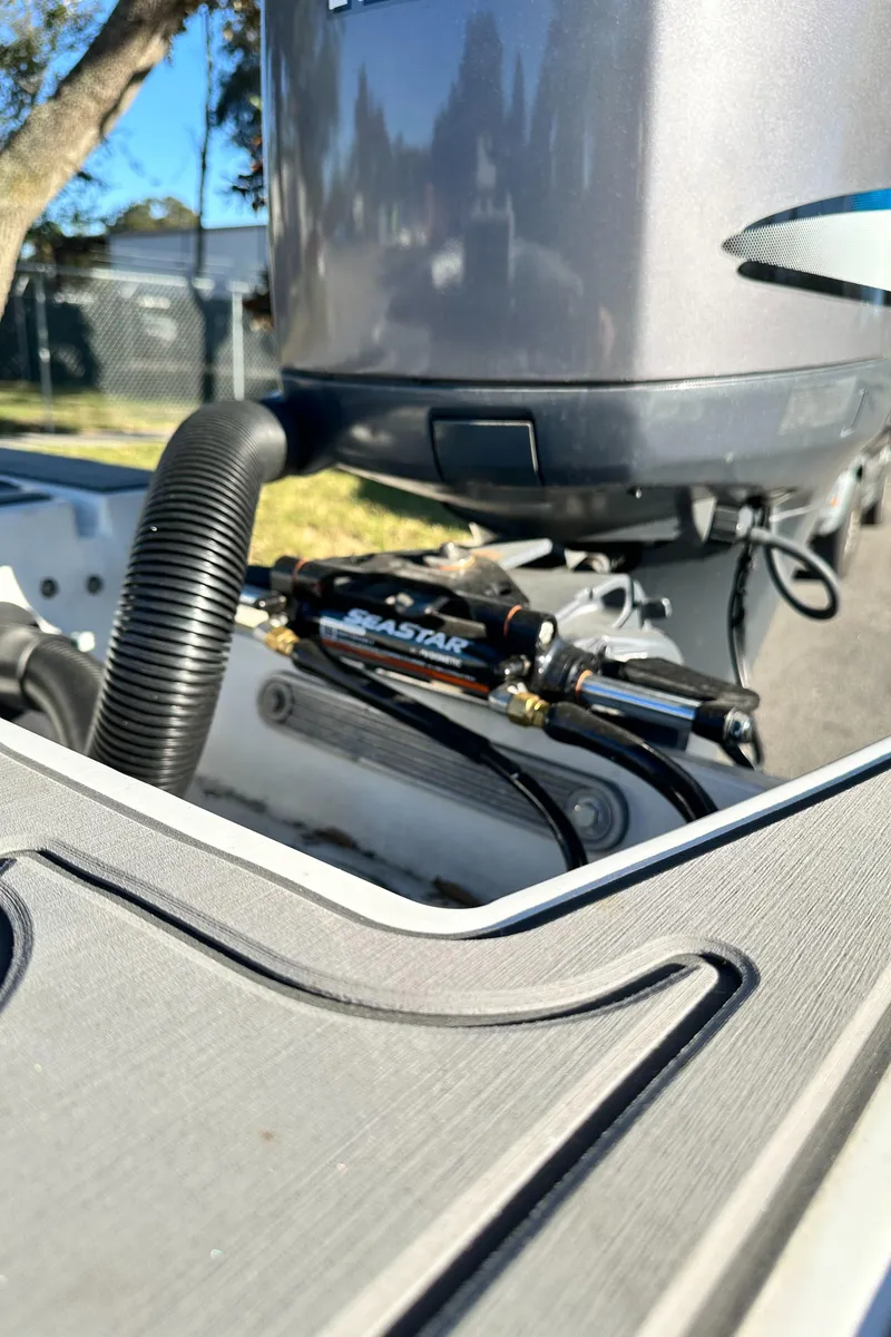 Slide: The Image of Close-up of a 1996 Hewes 18 Redfisher boat engine with SeaStar hydraulic steering. - 23