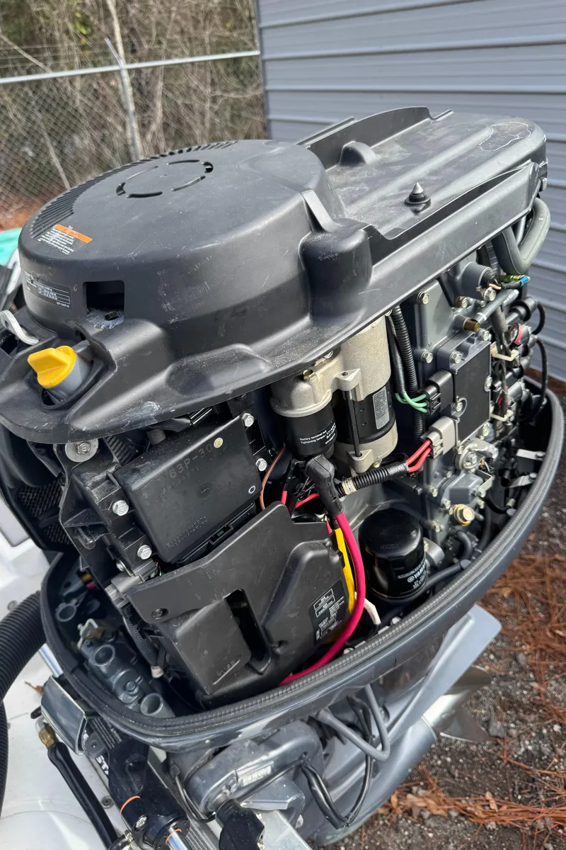 Slide: The Image of Close-up of a 1996 Hewes 18 Redfisher boat engine, showcasing intricate mechanical details. - 24