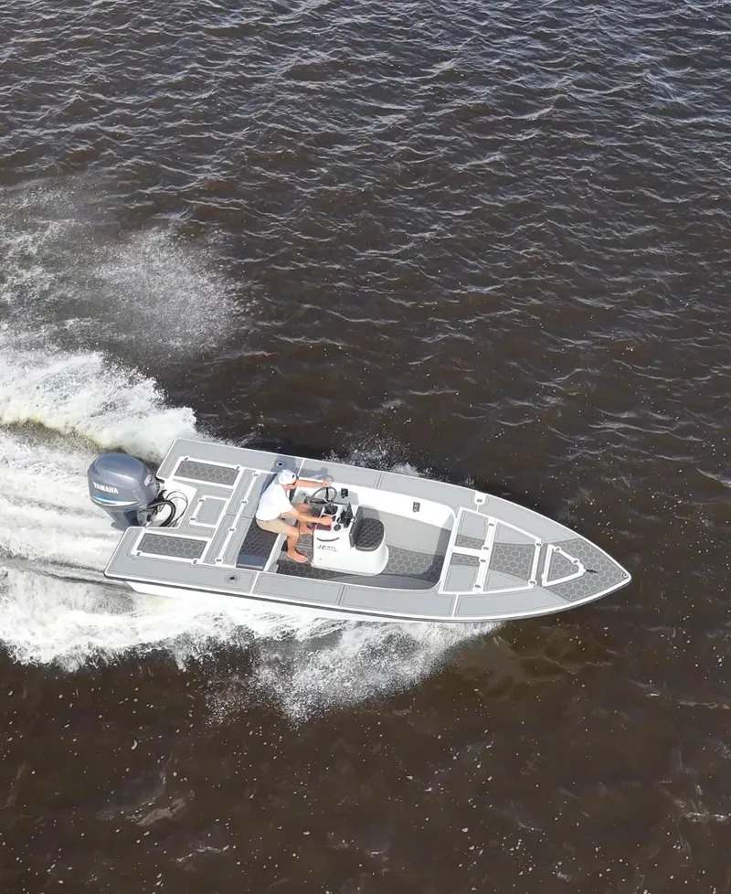 Slide: The Image of 1996 Hewes 18 Redfisher boat cruising on open water, aerial view. - 7