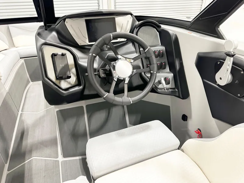Slide: The Image of 2025 Supreme S240 boat interior with modern steering wheel and control panel. - 10