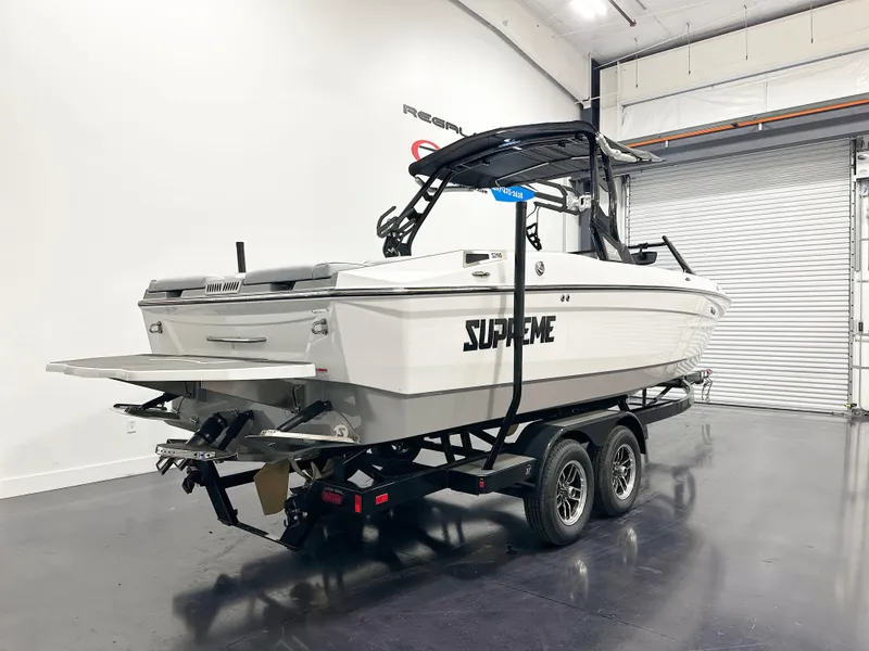 Slide: The Image of 2025 Supreme S240 boat on trailer in showroom, featuring sleek design and modern features. - 4