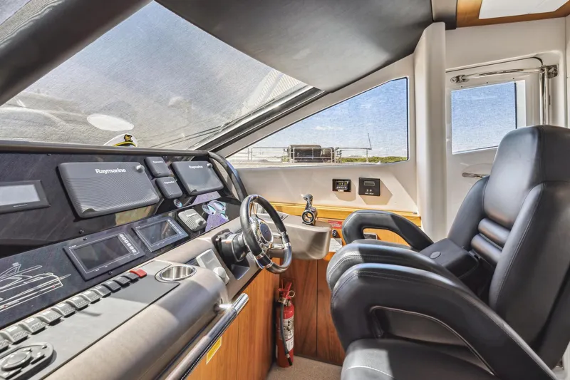 Slide: The Image of Interior helm of 2014 Sunseeker Manhattan 73 yacht with modern controls and leather seating. - 23