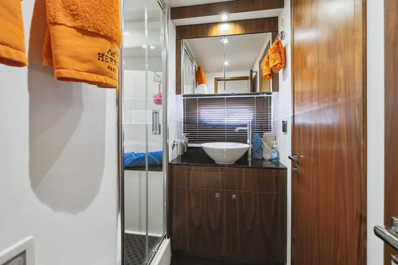 Slide: The Image of Luxurious bathroom in 2014 Sunseeker Manhattan 73 yacht with modern fixtures and wooden accents. - 32