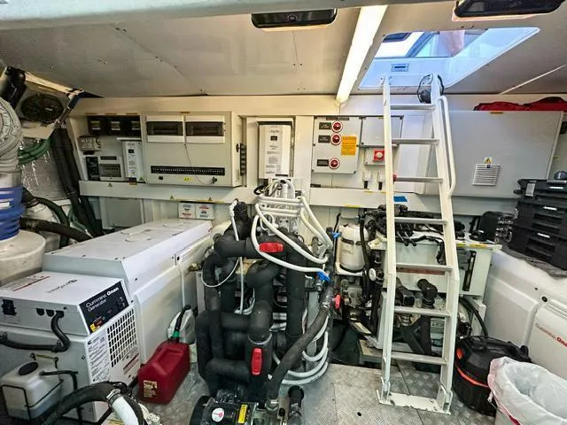 Slide: The Image of Engine room of 2014 Sunseeker Manhattan 73 yacht, featuring equipment and control panels. - 39