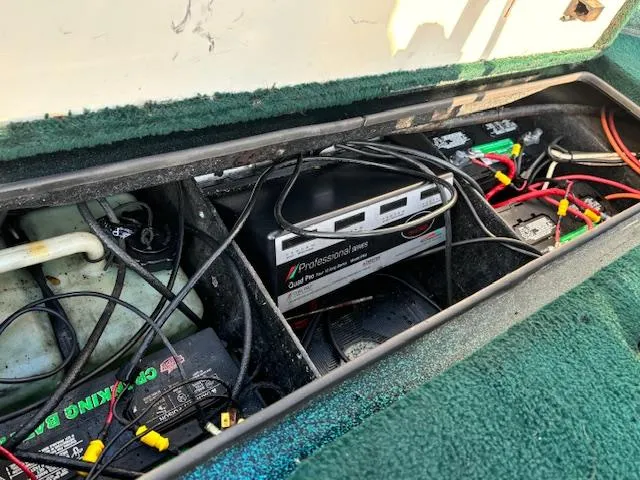 Slide: The Image of 1998 Ranger 518DVX boat battery compartment with wiring and charger. - 14