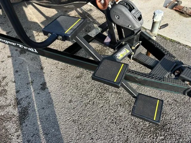 Slide: The Image of 1998 Ranger 518DVX boat trailer with sturdy black metal steps and yellow accents. - 2