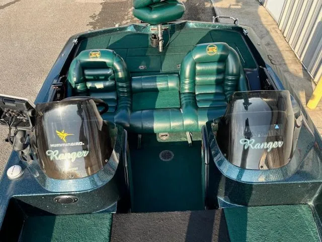 Slide: The Image of 1998 Ranger 518DVX boat interior with green seats and dual consoles. - 9