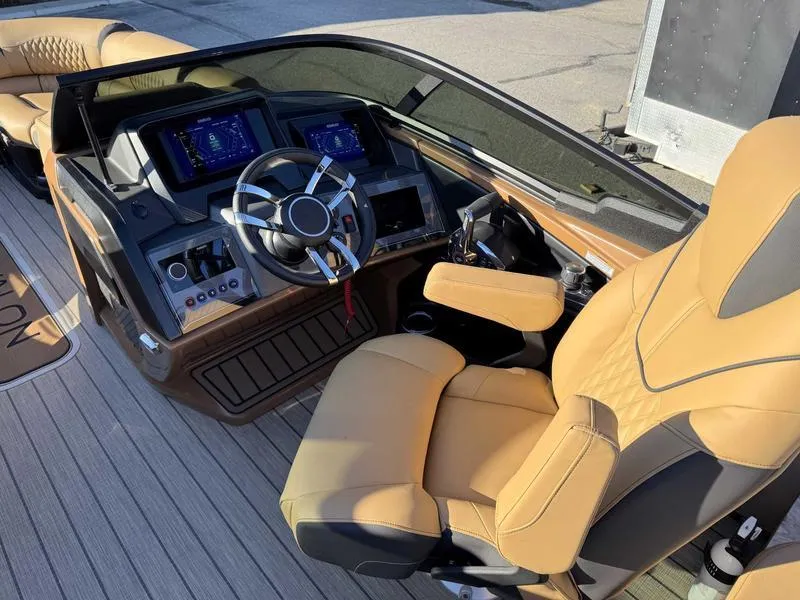 Slide: The Image of Luxurious 2025 Avalon 2585 Excalibur LTD QL boat interior with modern dashboard and leather seating. - 11