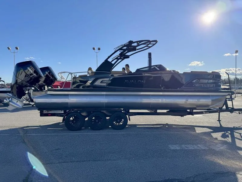 Slide: The Image of 2025 Avalon 2585 27-3 Excalibur LTD QL pontoon boat on trailer, sunny day. - 5