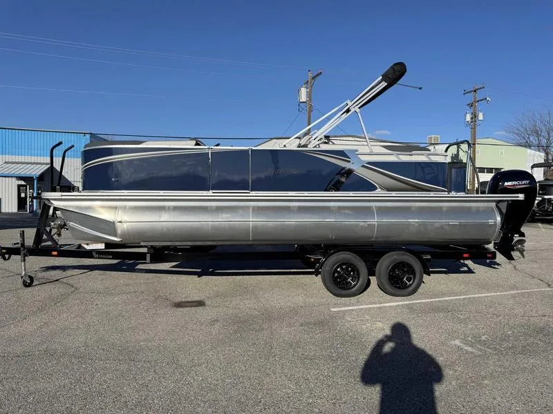 Slide: The Image of 2025 Avalon 2385 25 LSZ QL pontoon boat on trailer in parking lot. - 1