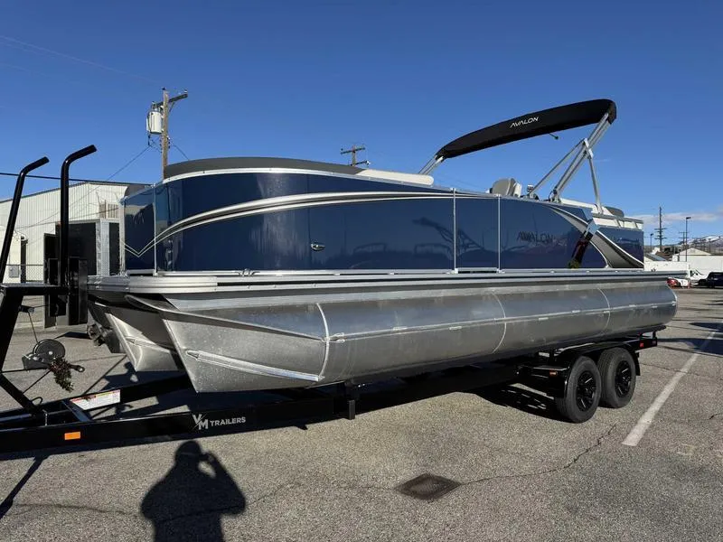 Slide: The Image of 2025 Avalon 2385 25 LSZ QL pontoon boat on trailer, parked outdoors. - 3