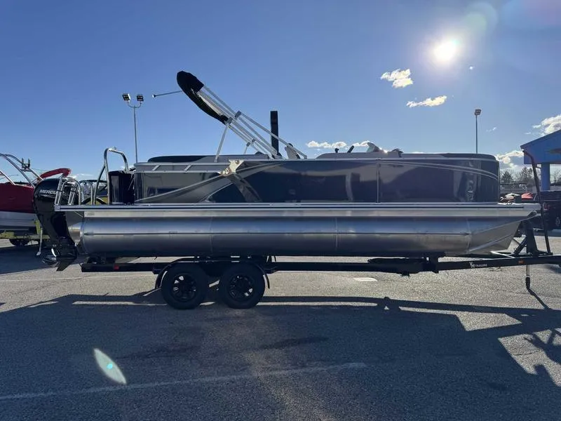 Slide: The Image of 2025 Avalon 2385 25 LSZ QL pontoon boat on trailer under sunny sky. - 6