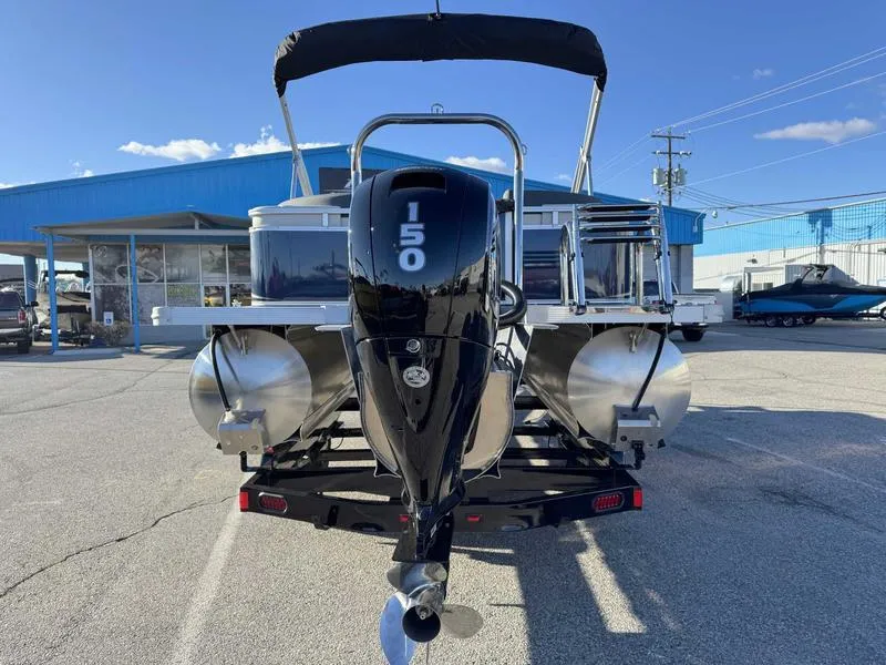 Slide: The Image of Avalon 2385 25 LSZ QL 2025 pontoon boat with 150 HP engine, parked outdoors. - 7