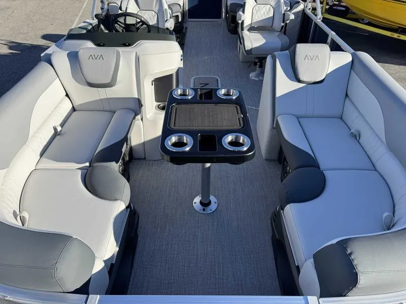 Slide: The Image of 2025 Avalon 2385 25 LSZ QL pontoon boat interior with plush seating and central table. - 8