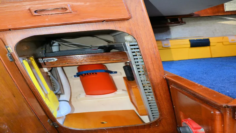 Slide: The Image of Interior view of a 1982 Morgan 32 sailboat showing storage compartment and equipment. - 20