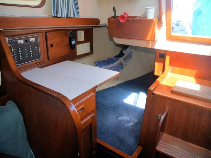 Slide: The Image of 1982 Morgan 32 yacht interior with wooden cabinetry and blue carpet. - 21