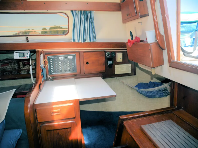 Slide: The Image of 1982 Morgan 32 yacht interior with navigation station and wooden cabinetry. - 22