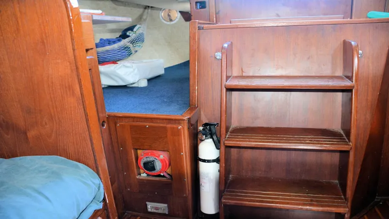 Slide: The Image of Interior of 1982 Morgan 32 sailboat with wooden steps and cozy cabin space. - 24