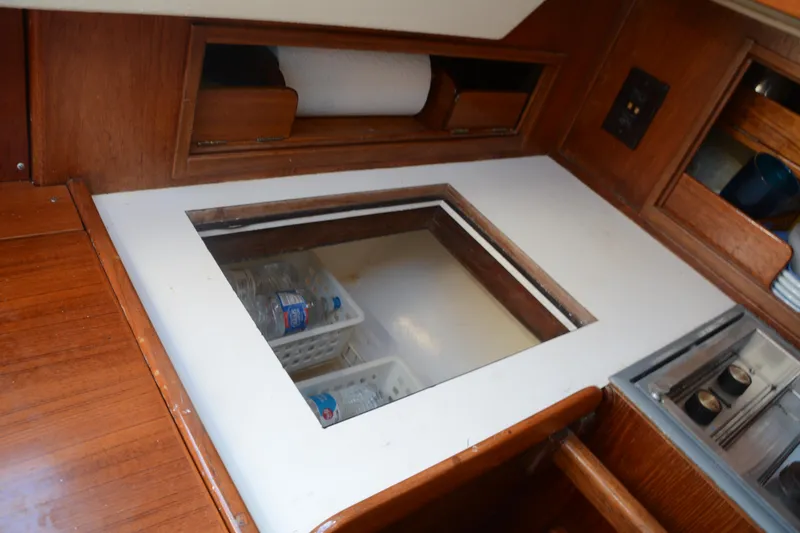 Slide: The Image of 1982 Morgan 32 yacht interior with wooden cabinetry and built-in storage compartments. - 28