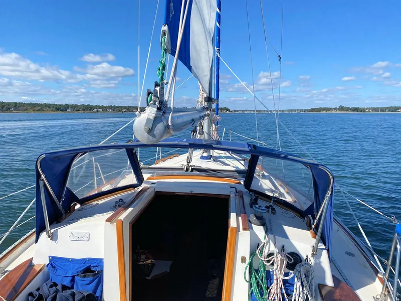 Slide: The Image of 1982 Morgan 32 sailboat on calm waters under clear blue sky. - 3