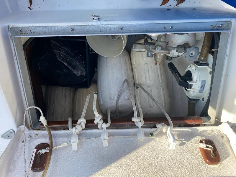 Slide: The Image of Storage compartment on a 1982 Morgan 32 boat with ropes and equipment. - 33
