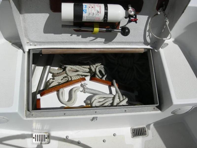 Slide: The Image of Open storage compartment on 1982 Morgan 32 boat with ropes and fire extinguisher. - 34