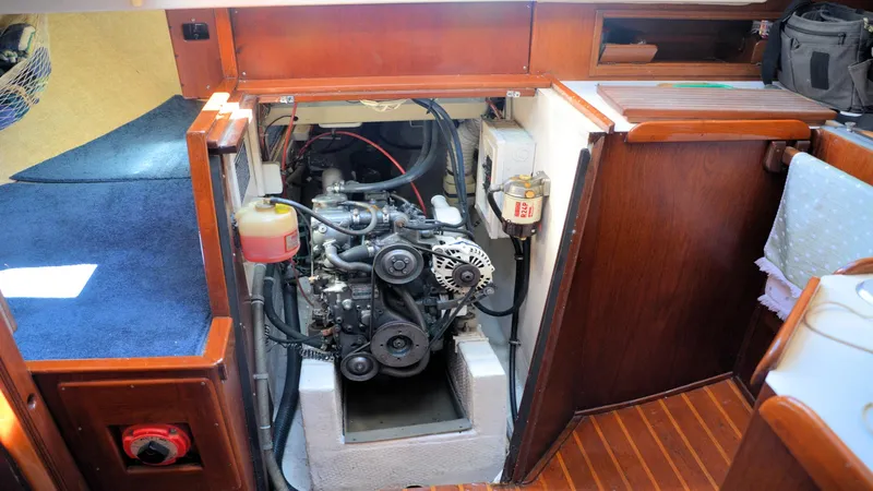 Slide: The Image of Engine compartment of a 1982 Morgan 32 sailboat, showcasing detailed mechanical components. - 37