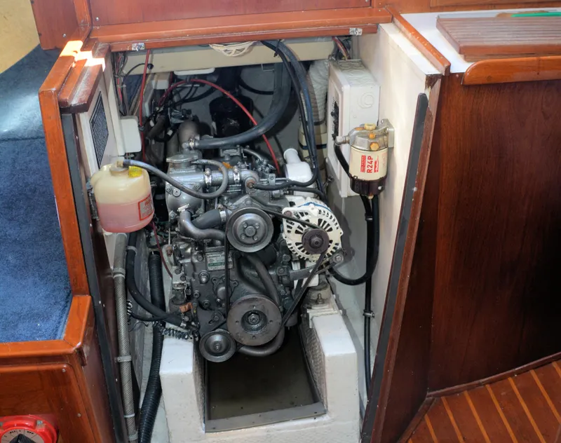 Slide: The Image of 1982 Morgan 32 sailboat engine compartment with visible mechanical components and wiring. - 39