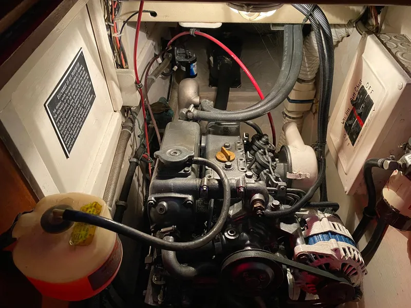 Slide: The Image of Engine compartment of a 1982 Morgan 32 sailboat, showcasing mechanical components and wiring. - 41