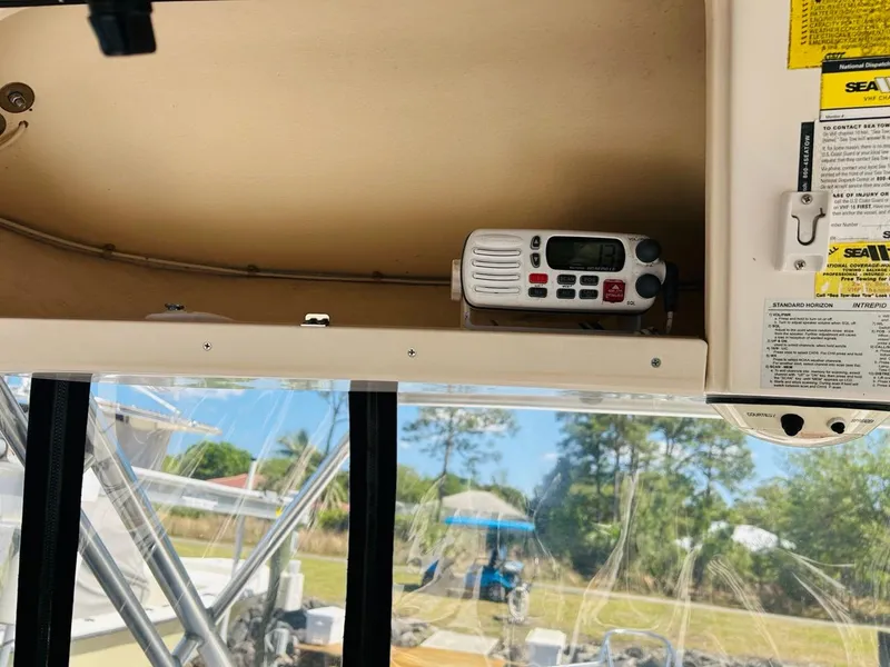 Slide: The Image of 2002 Grady-White Express 265 boat interior with radio equipment and outdoor view. - 12