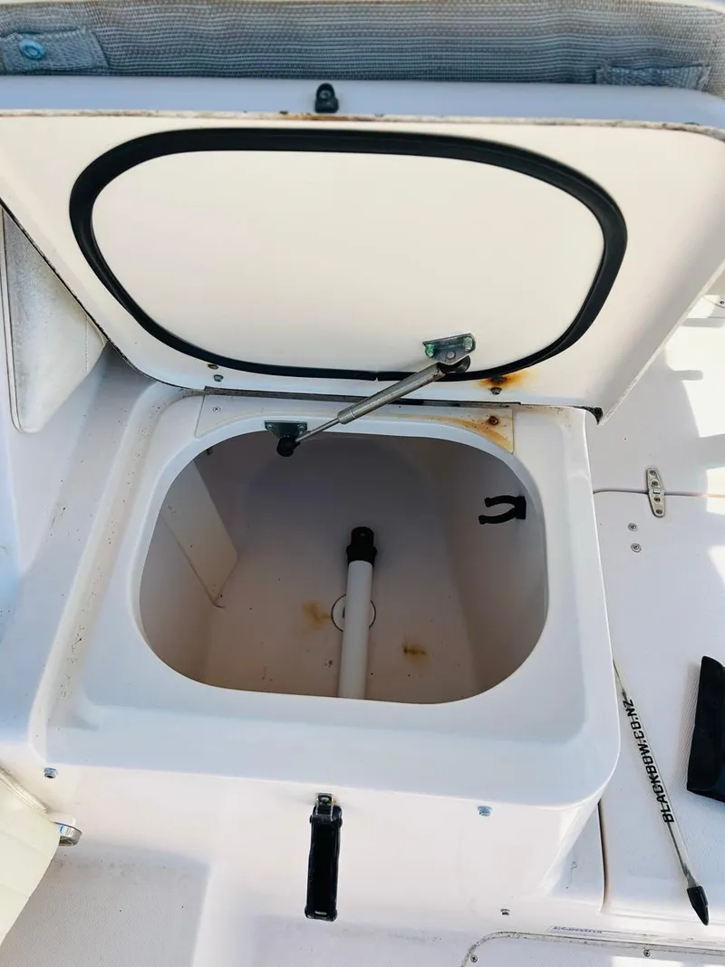 Slide: The Image of Open storage compartment on a 2002 Grady-White Express 265 boat. - 13