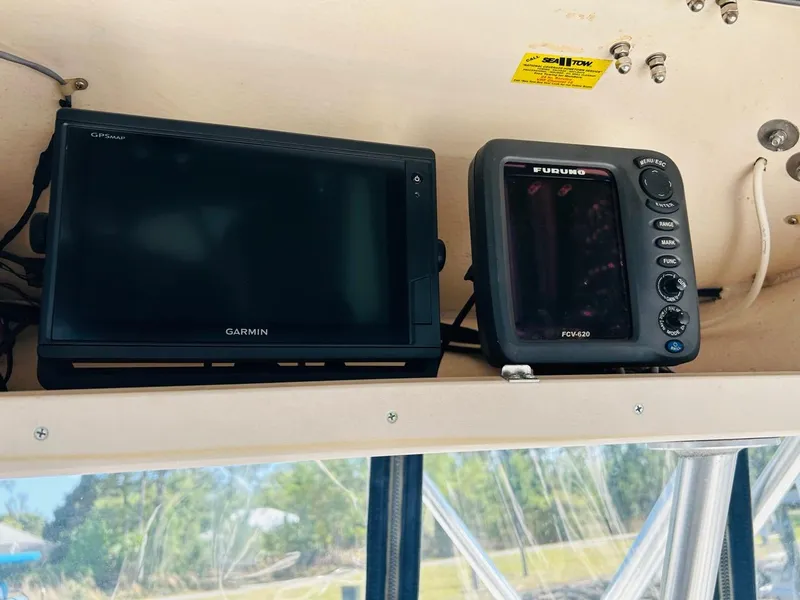 Slide: The Image of Garmin and Furuno navigation systems on a 2002 Grady-White Express 265 boat. - 15