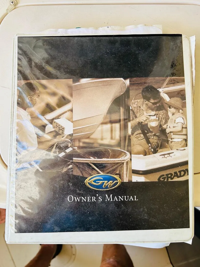 Slide: The Image of 2002 Grady-White Express 265 owner's manual cover with boating imagery. - 17
