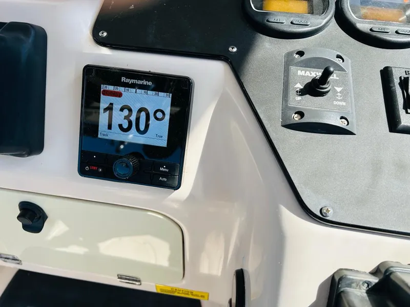 Slide: The Image of Dashboard of 2002 Grady-White Express 265 with Raymarine display showing 130 degrees. - 21
