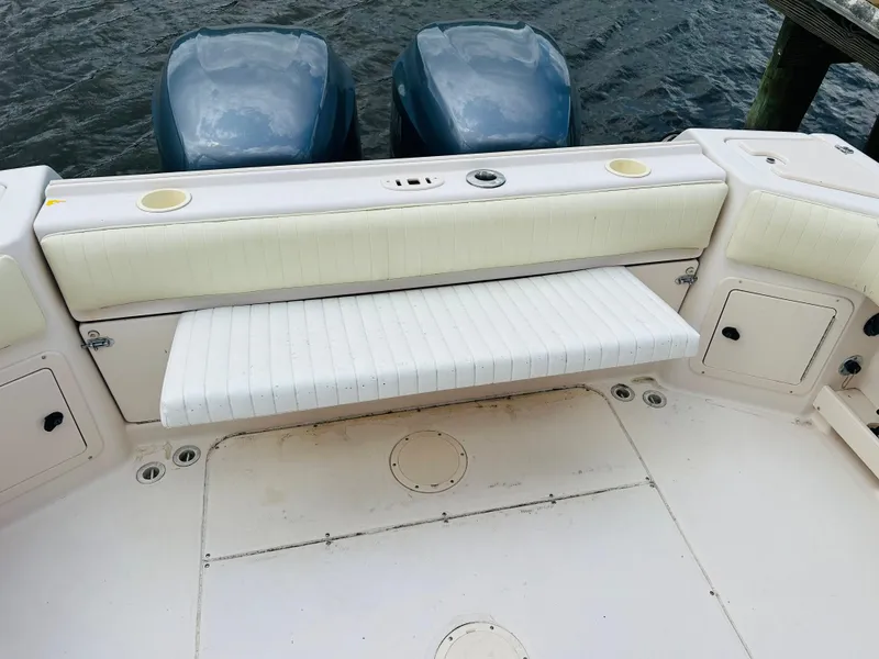 Slide: The Image of 2002 Grady-White Express 265 boat deck with seating and twin engines. - 24