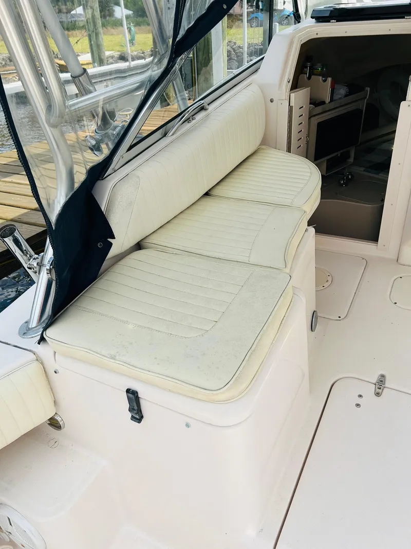 Slide: The Image of 2002 Grady-White Express 265 boat interior with cushioned seating. - 25