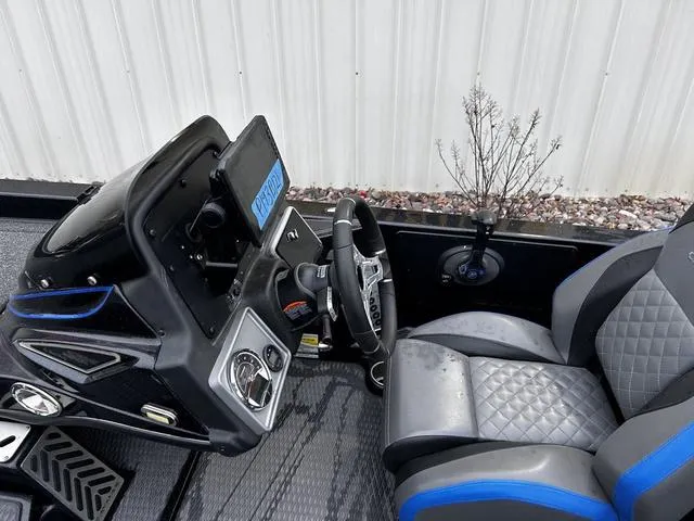 Slide: The Image of 2021 Caymas CX 21 boat interior with steering wheel and seat, featuring modern design elements. - 13