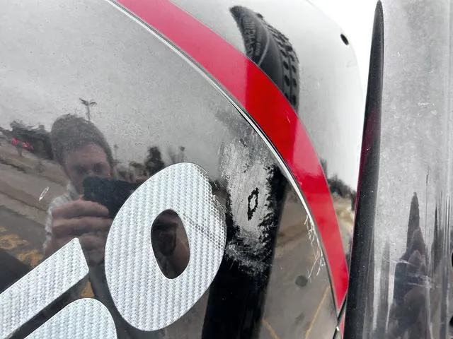 Slide: The Image of Close-up of a 2021 Caymas CX 21 boat with visible scratch and reflection. - 4