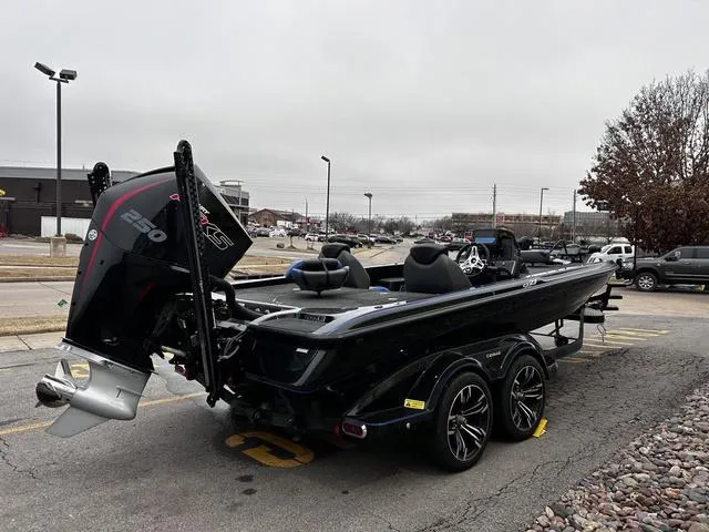 Slide: The Image of 2021 Caymas CX 21 boat with powerful engine, parked outdoors on a cloudy day. - 6