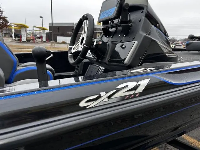 Slide: The Image of 2021 Caymas CX 21 boat interior, featuring steering wheel and dashboard controls. - 7
