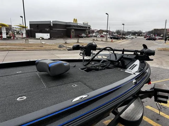 Slide: The Image of 2021 Caymas CX 21 boat parked near a fast-food restaurant, showcasing its deck and equipment. - 8