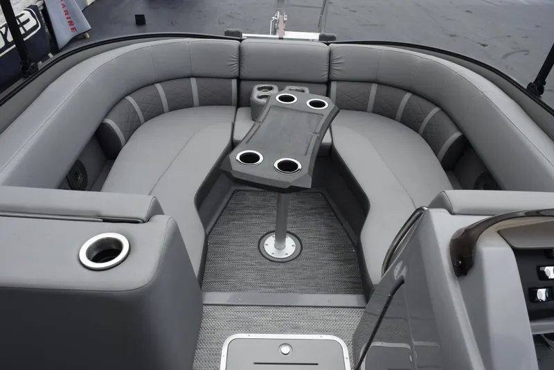 Slide: The Image of 2023 Bennington 23 LTFB boat interior with gray seating and cupholders. - 12
