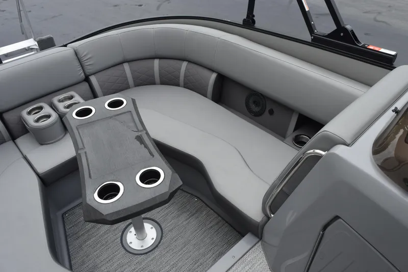 Slide: The Image of 2023 Bennington 23 LTFB boat interior with gray seating and cupholders. - 13