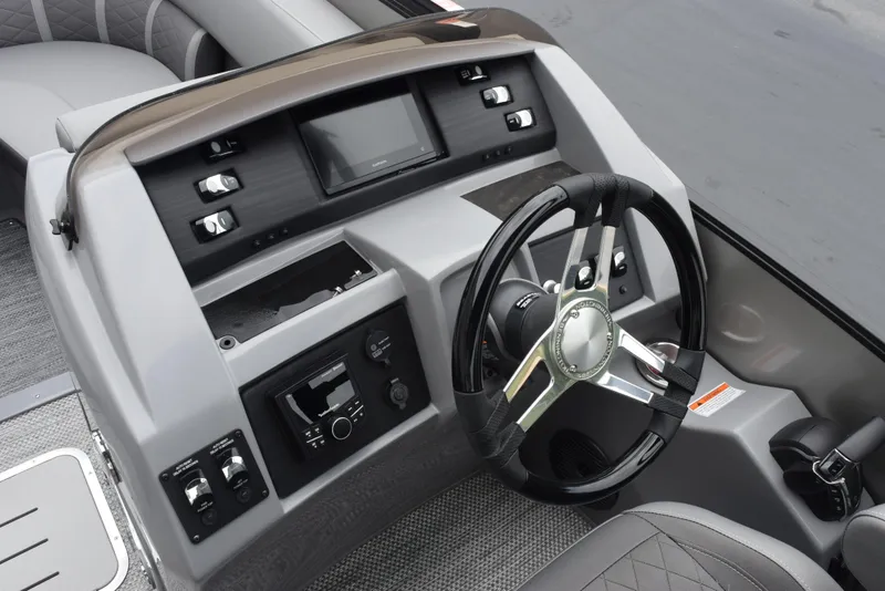 Slide: The Image of 2023 Bennington 23 LTFB boat dashboard with steering wheel and control panel. - 15