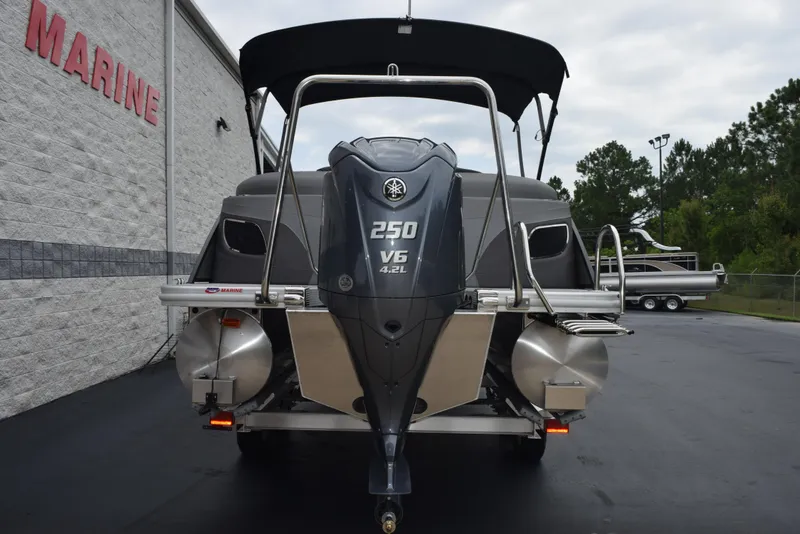Slide: The Image of 2023 Bennington 23 LTFB pontoon boat with Yamaha 250 V6 engine, parked at a marine dealership. - 5