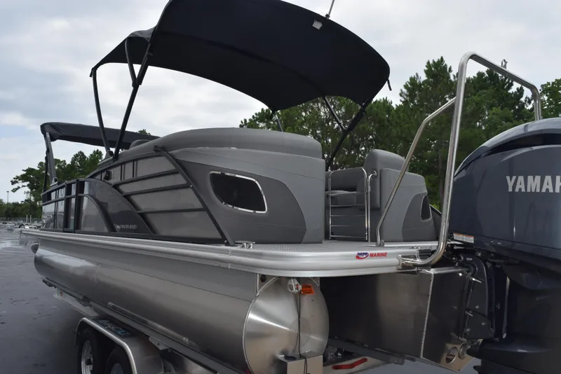 Slide: The Image of 2023 Bennington 23 LTFB pontoon boat with Yamaha engine, parked on a trailer. - 6