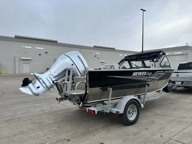 Slide: The Image of 2021 Hewescraft Sportsman 180 SM boat on trailer in parking lot. - 3